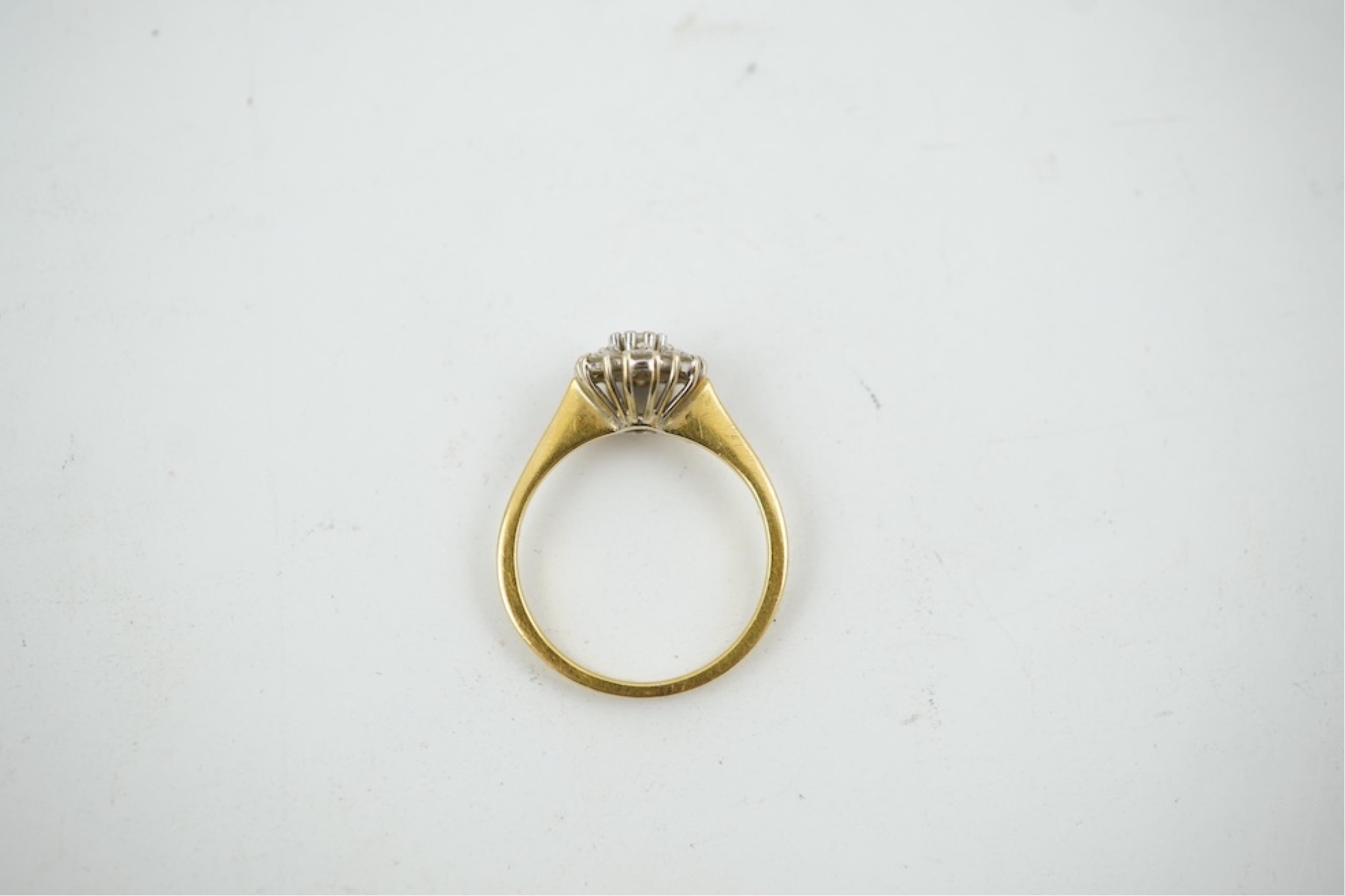 A modern 18ct gold and diamond set circular cluster ring, size M, gross weight 3.2 grams.